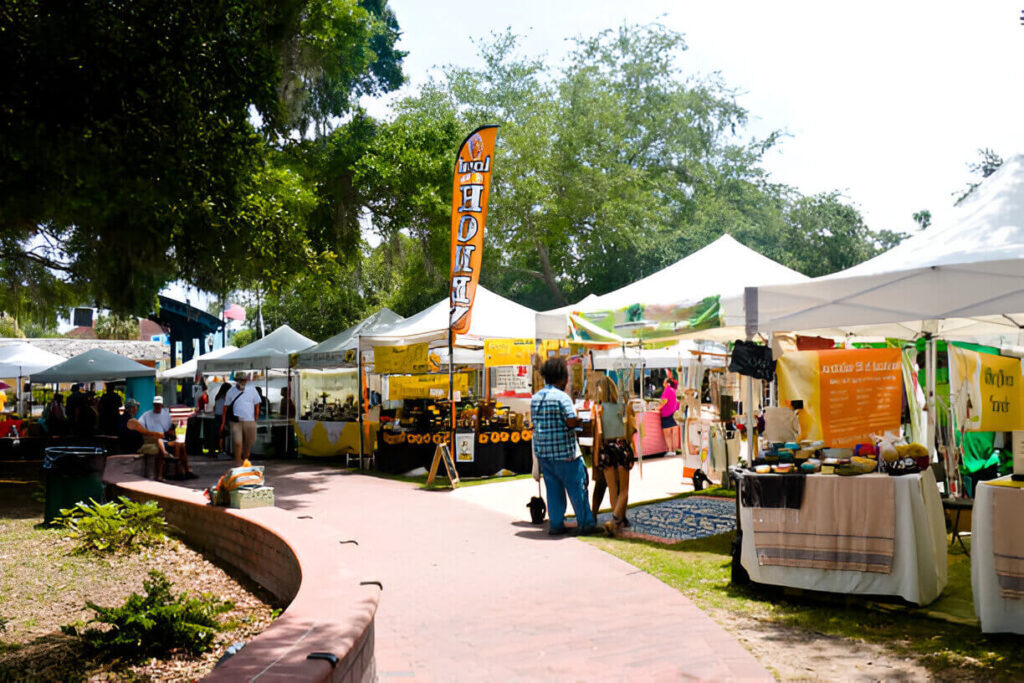 A large tree is featured in the background of an outdoor vs indoor displays.